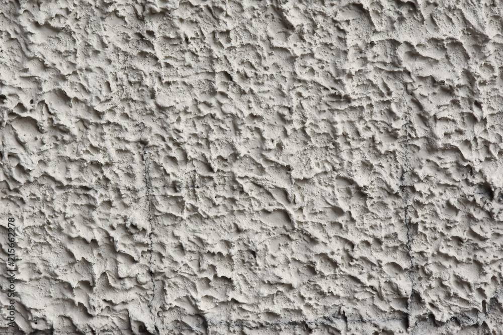 Stucco applied by machine method, rough smears. Grey colour