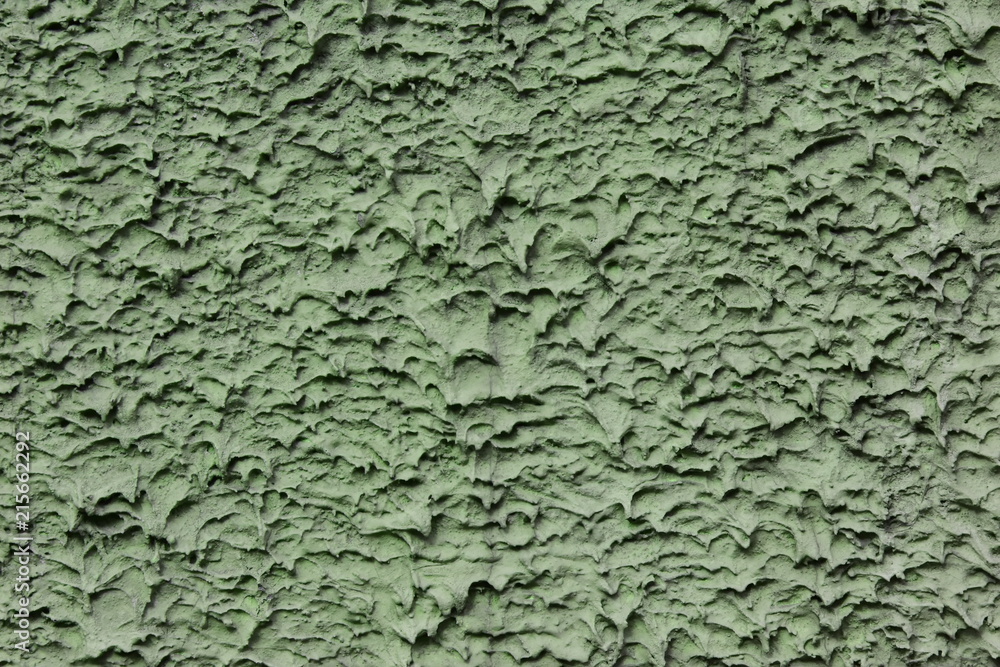 Stucco applied by machine method, rough smears. Green colour Stucco applied by machine method, rough smears. Green colour