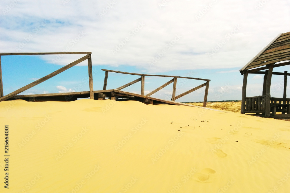 Desert landscape. Wooden structures on sand. Desert landscape. Wooden structures on sand.