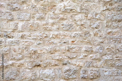 Light colour stone wall background texture.