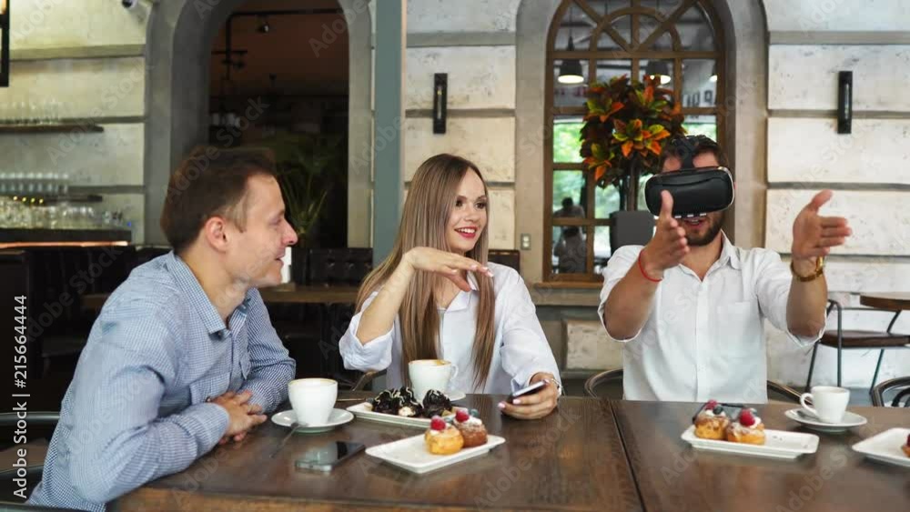 Team of developers working with virtual reality glasses during a business meeting. Young business colleagues brainstorming using VR goggles Team of developers working with virtual reality glasses during a business meeting. Young business colleagues brainstorming using VR goggles