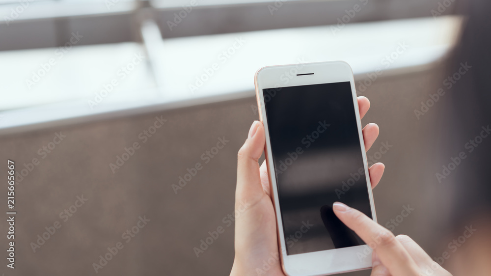 woman using smartphone on staircase in public areas, During leisure time. The concept of using the phone is essential in everyday life.