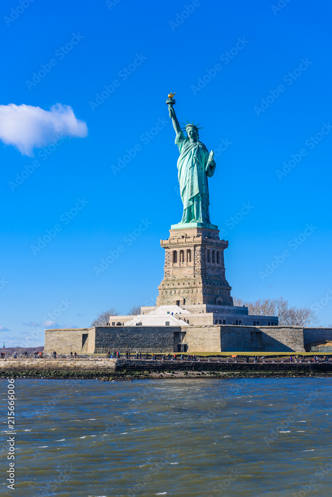 The statue of Liberty at a sunny day with blue sky, New York City, USA