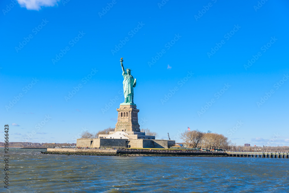 The statue of Liberty at a sunny day with blue sky, New York City, USA