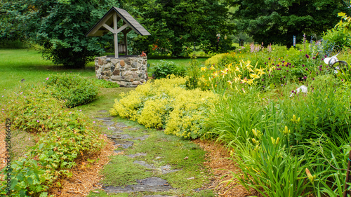 plant covered stone path winding through perennial garden in summer  photo