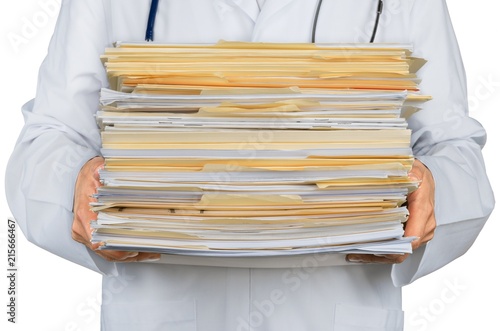 Close-up of a Doctor with Stack of Documents / Files