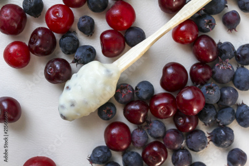 White chocolate candy with cherry and shadberries