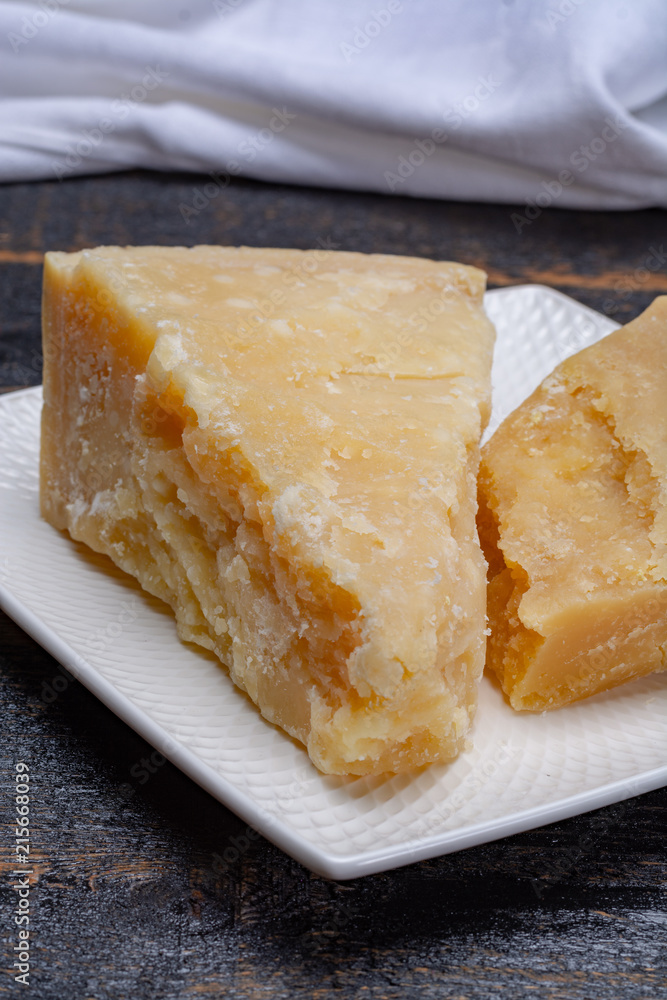 Traditional italian food - 36 months aged in caves Italian parmesan hard cheese from Parmigiano-Reggiano, Italy Traditional italian food - 36 months aged in caves Italian parmesan hard cheese from Parmigiano-Reggiano, Italy