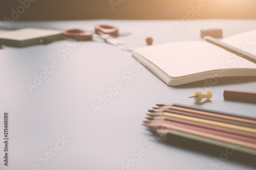 Back to school concepty with student stuff on clear table with sunlight and vintage tone photo