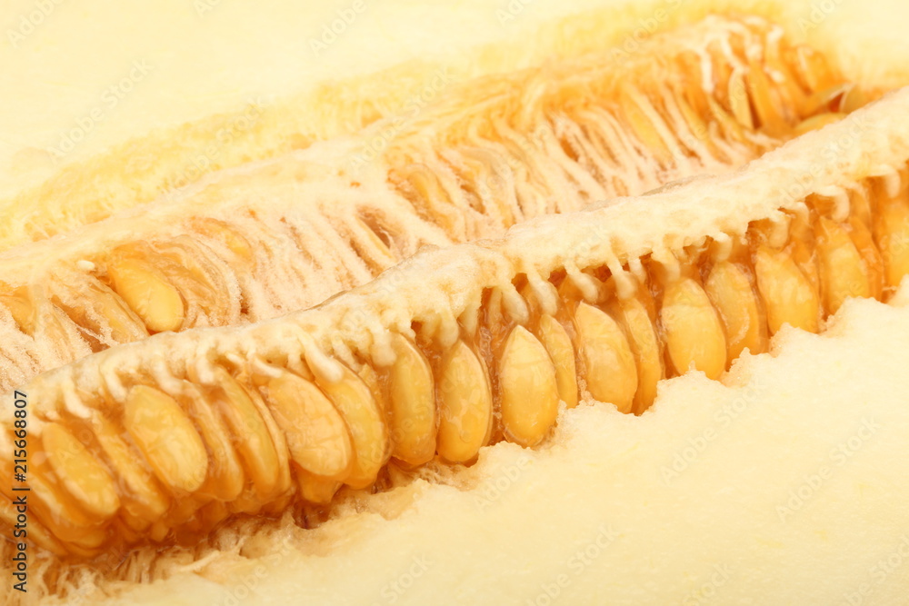 A view of a ripe melon with seeds cut in half close-up A view of a ripe melon with seeds cut in half close-up