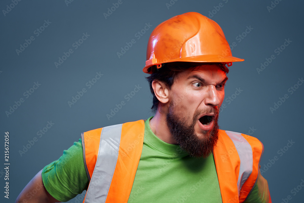 a builder in a helmet shouts a builder in a helmet shouts