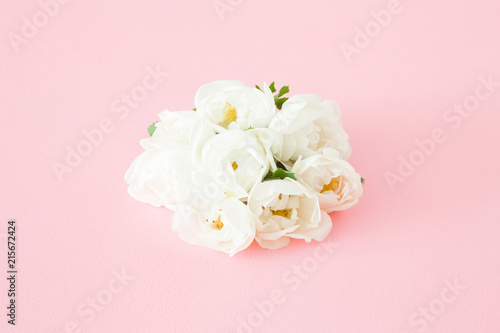 Beautiful, fresh wedding bouquet of white roses in the center on pastel pink background. Soft light color. Greeting card. Celebration day. Different festive congratulation concept.