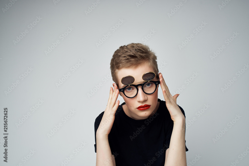 woman in glasses on a gray background woman in glasses on a gray background