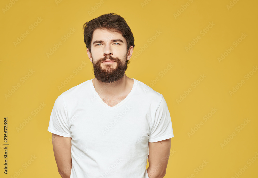 a man in a white T-shirt with a beard on a yellow background logo a man in a white T-shirt with a beard on a yellow background logo