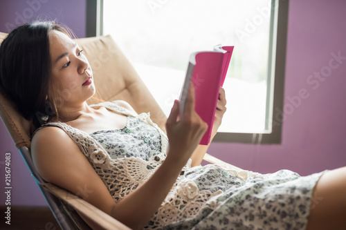 Asian woman read ficton book in house