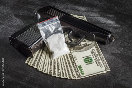 Drugs in a plastic bag with a bunch of dollars and a gun