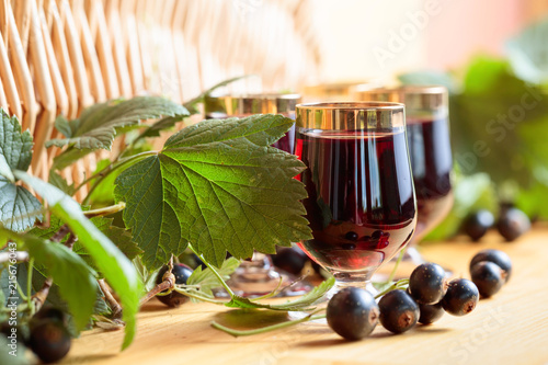 Homemade black currant liqueur and fresh berries.