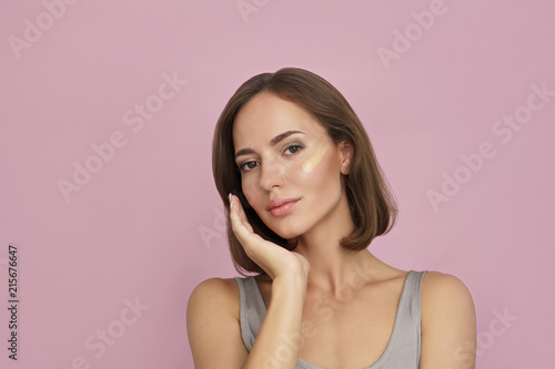 skin tone foundation line on young woman face, skin care concept
