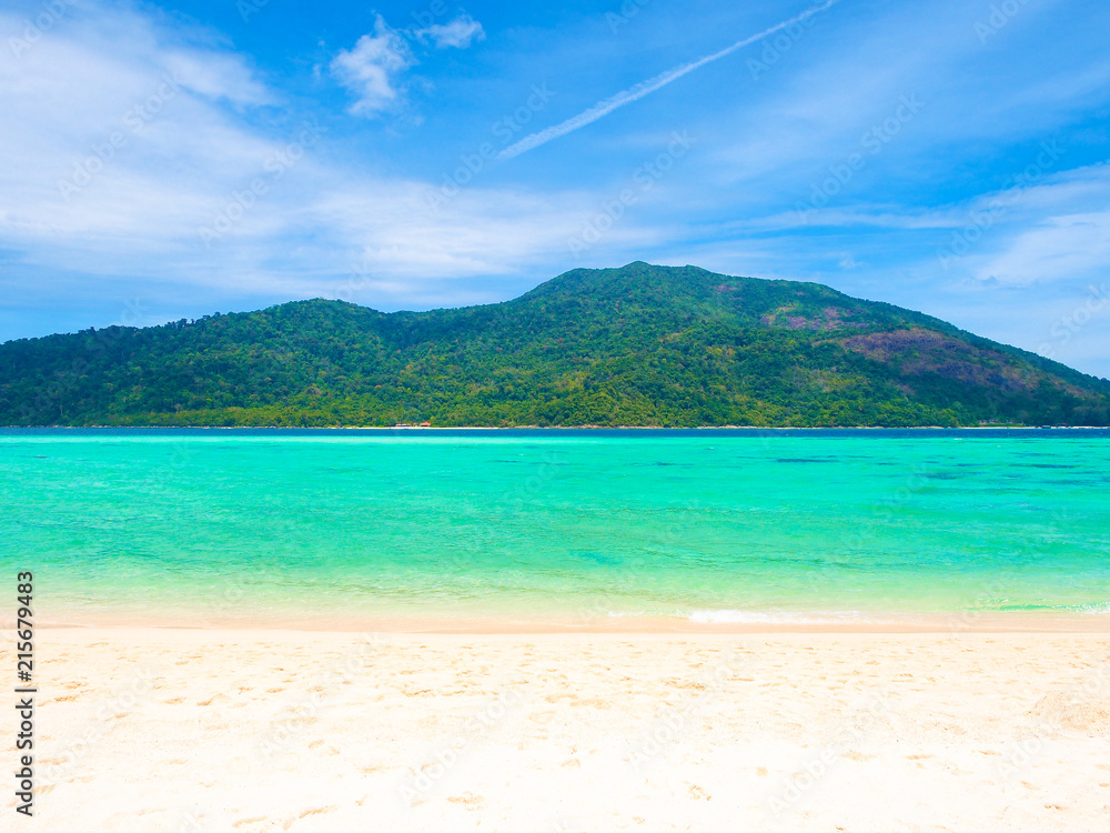 White sand beach and blue sea with mountain view in sunny summer day  for holiday or vacation concept.