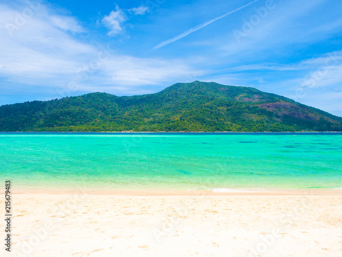 White sand beach and blue sea with mountain view in sunny summer day for holiday or vacation concept.