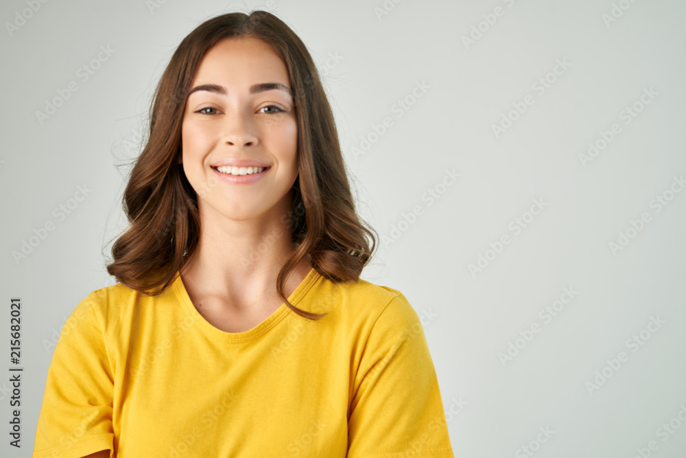 woman smiling in yellow T-shirt logo woman smiling in yellow T-shirt logo