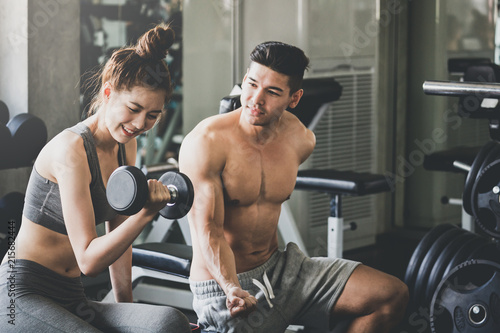 Fitness man and woman doing exercise in gym