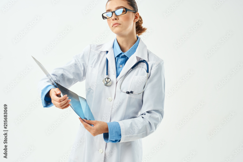 woman in white coat holding x-ray in hands woman in white coat holding x-ray in hands