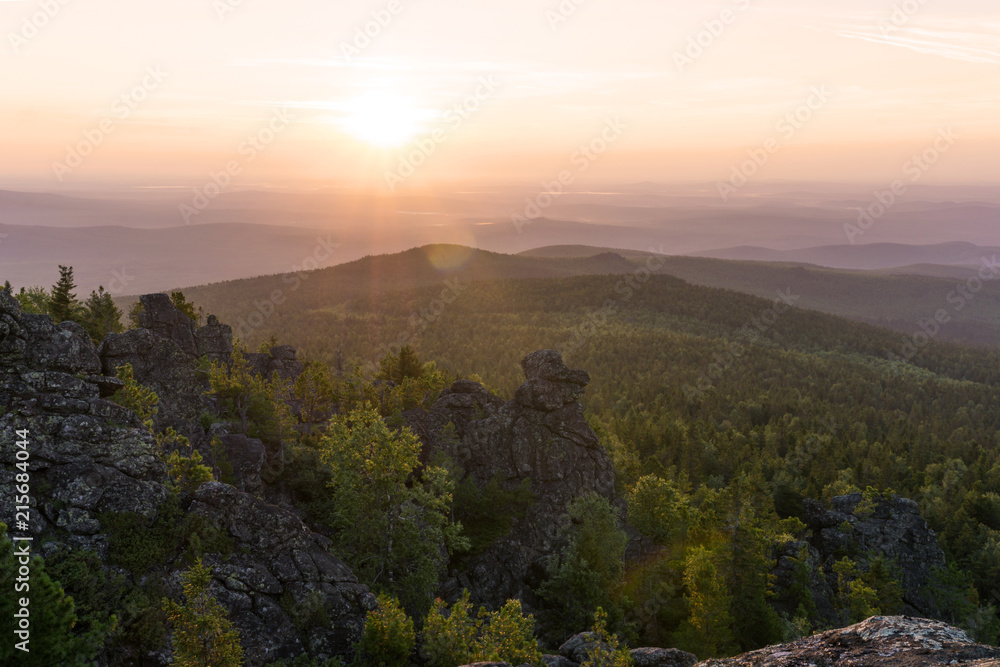 View from Mount Kachkanar, Middle Ural, at sunrise over misty valleys..