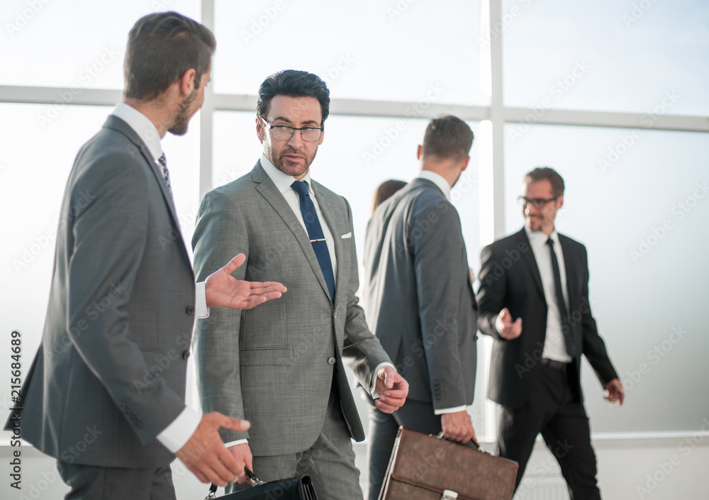 businessman talking with boss in industrial interior businessman talking with boss in industrial interior