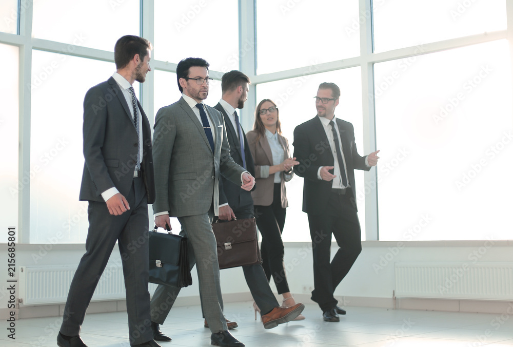 Businesspeople walking in the office background. Businesspeople walking in the office background.