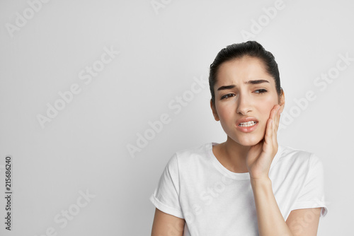 woman with a toothache on a light background treatment