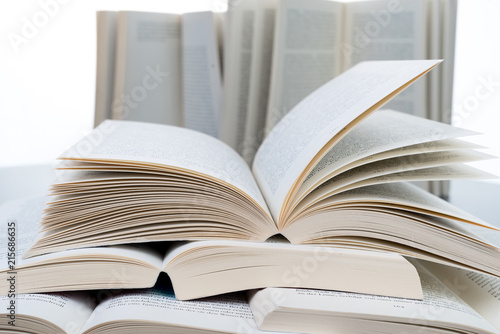Stack of open books lying on grey table