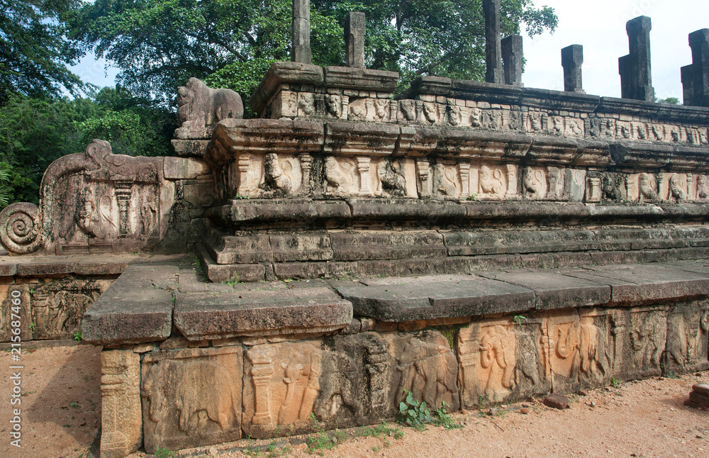 Fototapeta premium Foundations of the palace in ruined city Polonnaruwa with reliefs and columns, Sri Lanka. UNESCO World heritage Site