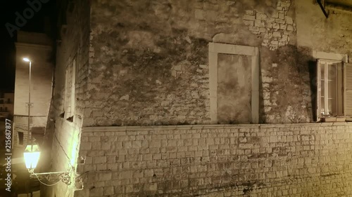 4k establishing shot, night aerial drone footage of a stone apartment building