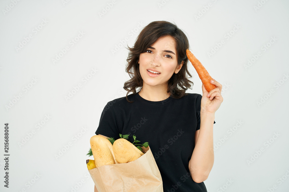 woman holds a grocery bag in her hand woman holds a grocery bag in her hand