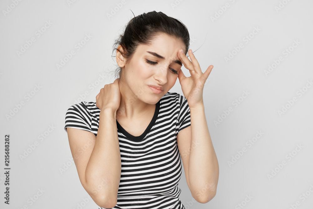 woman in a striped t-shirt is having a headache woman in a striped t-shirt is having a headache