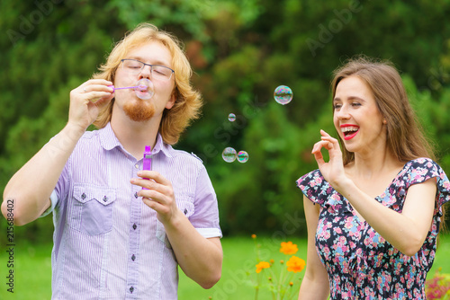 Couple blowing soap bubbles  having fun