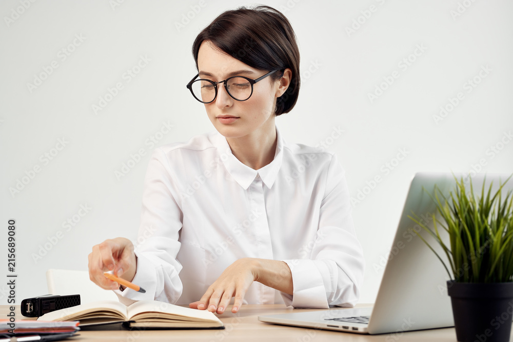 business woman with glasses working on a laptop business woman with glasses working on a laptop