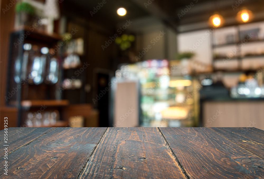 Wood floor, dark brown and background blur inside a cafe.