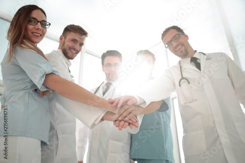 Doctors and nurses coordinate hands