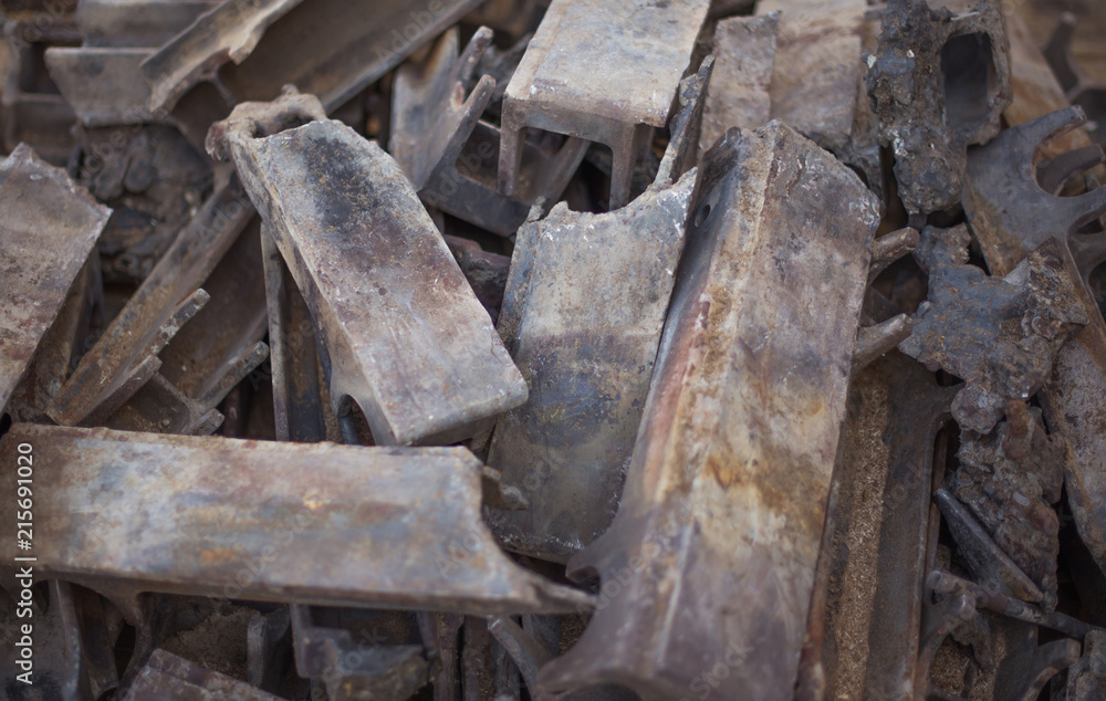 Pile of burnt-out cast iron parts of the industrial firebox. Selective focus.