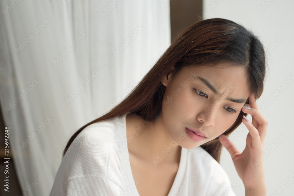 portrait of stressed sick woman with headache; ill woman suffers from vertigo, dizziness, migraine, hangover, health care concept; 20s young adult asian middle east or asian middle east woman model portrait of stressed sick woman with headache; ill woman suffers from vertigo, dizziness, migraine, hangover, health care concept; 20s young adult asian middle east or asian middle east woman model