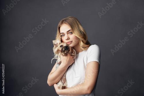 woman with dog on gray background