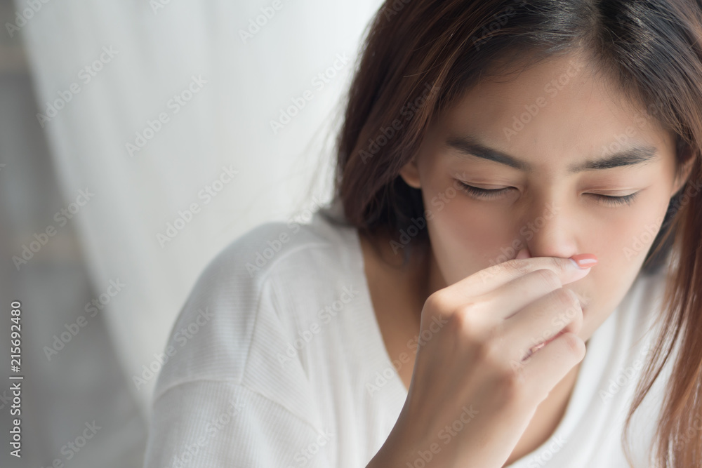 sick girl sniffle with runny nose; sick woman suffering from cold, flu, runny nose, trying to clear her nose; woman personal health care, pain, sickness concept; asian young adult woman model sick girl sniffle with runny nose; sick woman suffering from cold, flu, runny nose, trying to clear her nose; woman personal health care, pain, sickness concept; asian young adult woman model