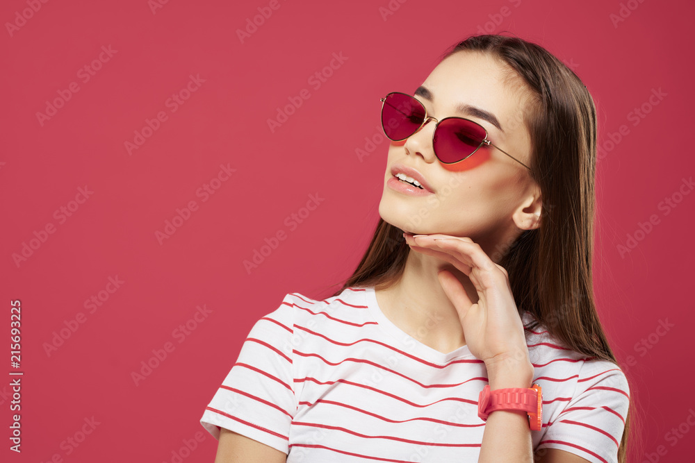 woman in glasses on a pink background
