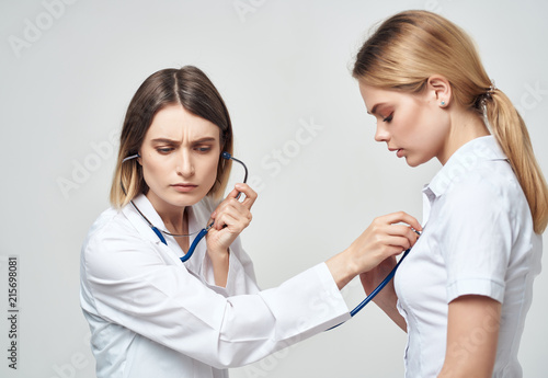 doctor listens to a patient with a stethoscope