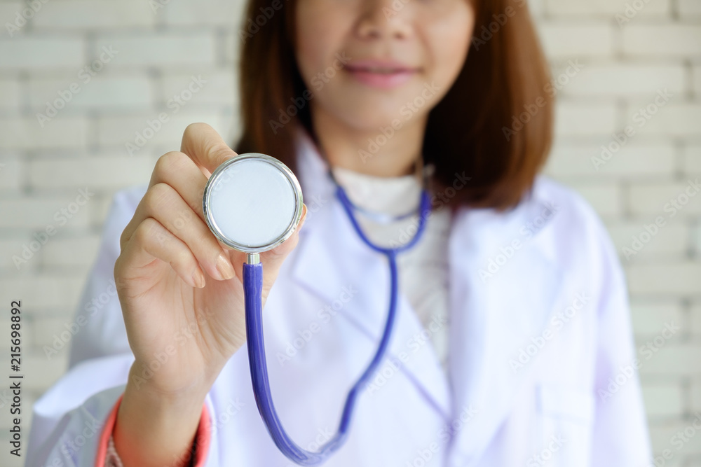 Female Doctor Hand holding purple stethoscope for Good Health check. Healthcare and Medicine concept. Selective focus image. Female Doctor Hand holding purple stethoscope for Good Health check. Healthcare and Medicine concept. Selective focus image.