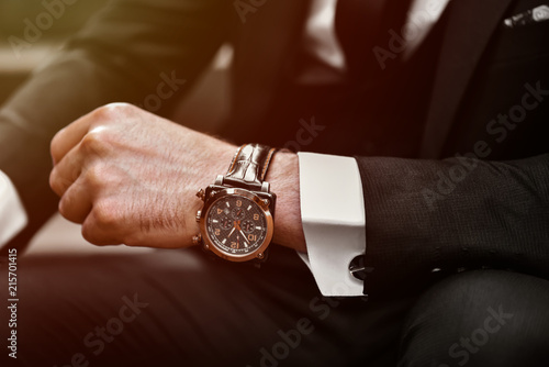 Wrist watch in a business suit. close up