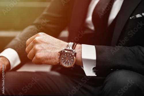 Wrist watch in a business suit. close up