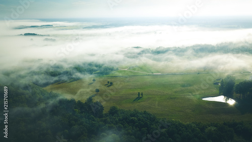 Misty sunrise over countryside path Aerial view Latvia